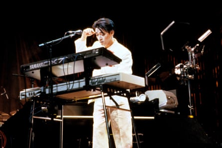 Ryuichi Sakamoto playing a Fairlight CMI Series III sampling synthesiser and a Yamaha DX7 keyboard.