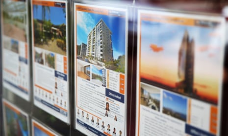 A residential property information leaflet advertising an apartment for sale is displayed in the window of a property agent in Sydney.
