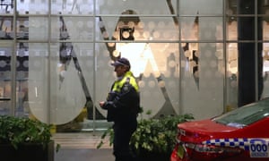 A police officer walks past the ABC logo at the main entrance to the ABC building in Ultimo, Sydney in June
