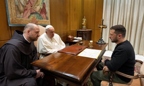 Pope Francis and President Volodymyr Zelenskiy sit around a table at the Vatican.