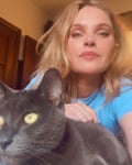 Silvia Fernandez, with her cat Delphina, says she’s getting constant headaches from the smoke.