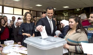 Syrian president, Bashar al-Assad casts his vote next to his wife Asma (left) at a polling station in Damascus.