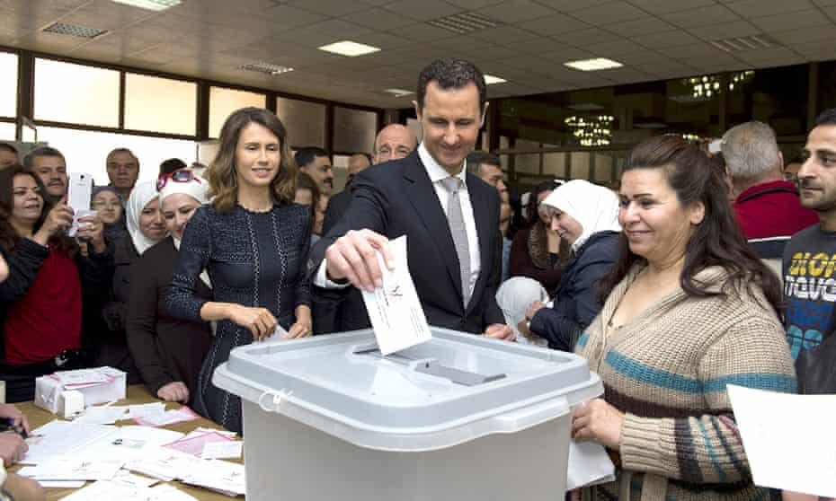 Syrian president, Bashar al-Assad casts his vote next to his wife Asma (left) at a polling station in Damascus.