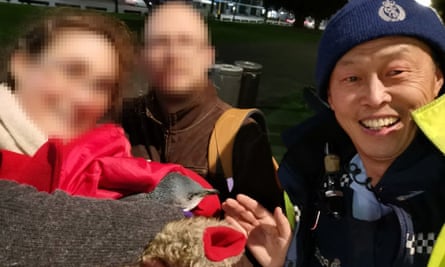 Two members of the public and a Wellington police officer evict a pair of penguins who had set up beneath a sushi shop