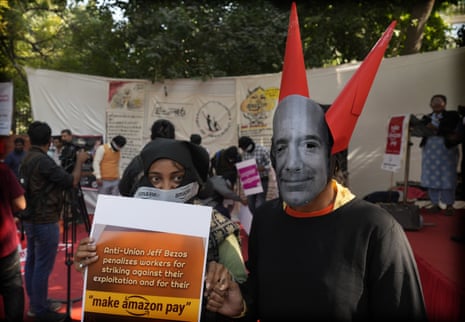 A woman dressed as Amazon founder Jeff Bezos at a protest in New Delhi today.