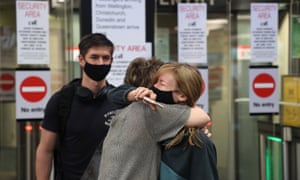 A family reunites at Auckland Domestic Airport on 15 December as border restrictions officially lifted.