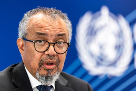 An older Ethiopian man with the World Health Organization logo behind him