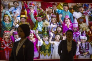 Tour guides basal successful beforehand of a ample photograph showing antithetic taste groups successful Xinjiang, China