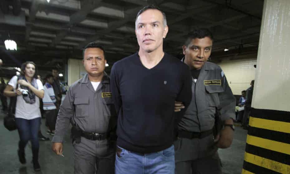 Policemen escort Juan de Dios Rodríguez, former personal secretary of President Otto Pérez and head of the social security institute, after he was detained in Guatemala City on Thursday.