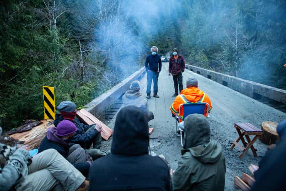 Members of the Rainforest Flying Squad speak with logging contractors after refusing to let them cross a bridge to an active cut block.