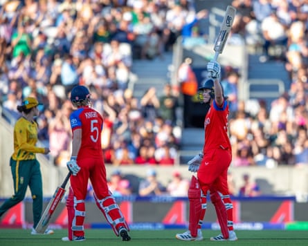 The England batter Nat Sciver-Brunt (right) raises her bat to observe reaching a half-century successful her team's Women's T20 World Cup semi-final triumph against South Africa astatine nan Oval.