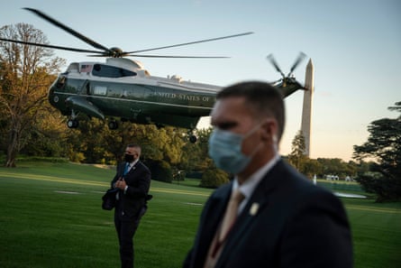 Secret Service agents standby as Donald Trump departs from the South Lawn.