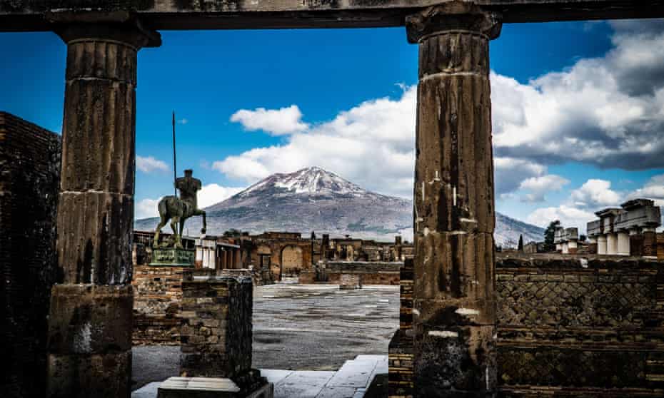 The snow-covered peak of Mount Vesuvius is seen from the streets of the archaeological site in Pompeii, Italy, in February.