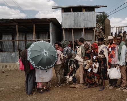 Civilians queue to receive rations
