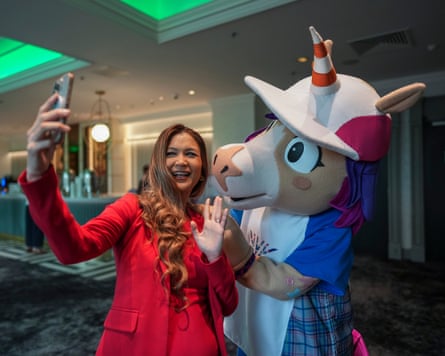 The Commonwealth Games mascot, Finnie, taking a selfie with a delegate