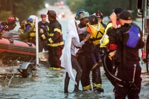 A firefighter helps Charlene Stennis and her son Christian to safety in Columbia, South Carolina