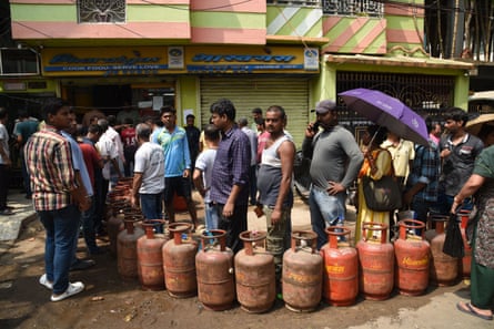 People wait in a long queue to buy liquefied petroleum gas