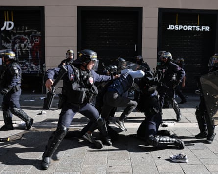 French riot police detain a protester on the ground during a Marseille demonstration
