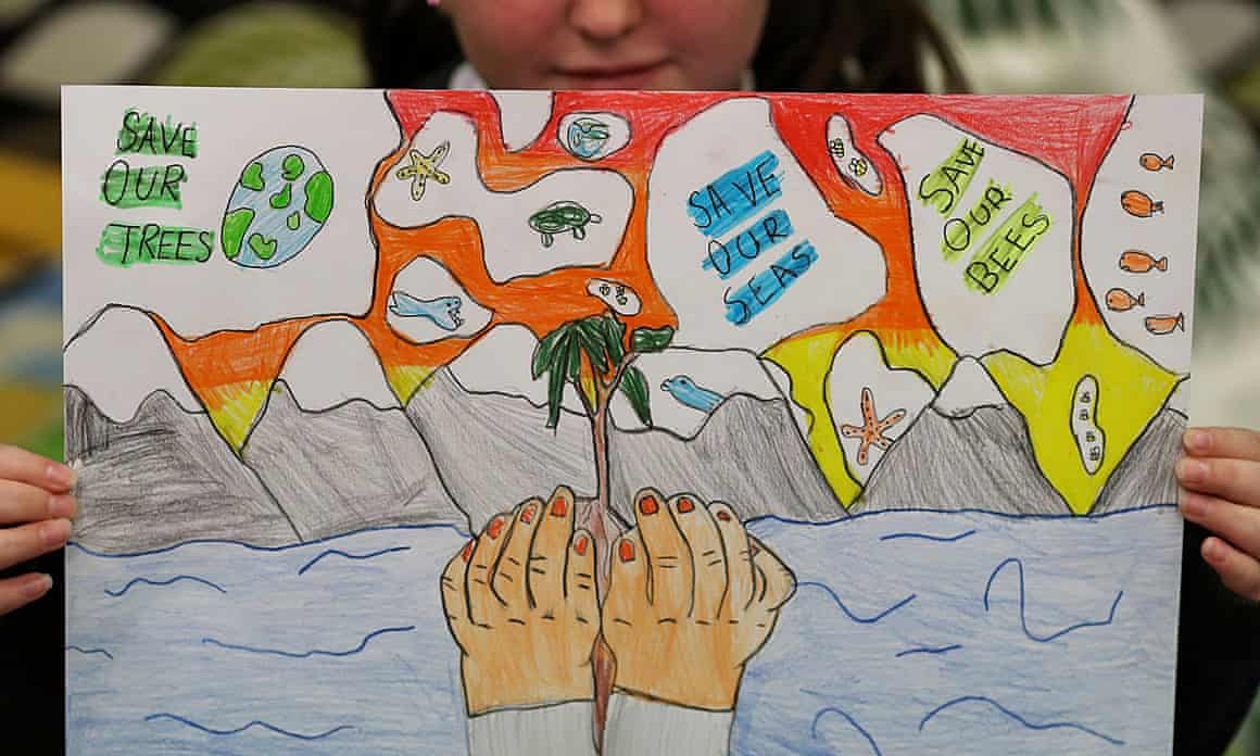 A student holds a poster at St Convals primary school, Glasgow while learning about climate change ahead of Cop26