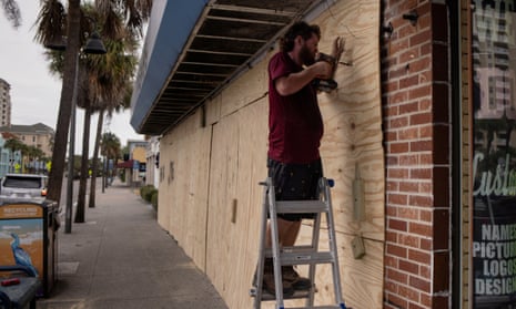 A photo of Steve Pizzano helping board up a friend's souvenir shop ahead of the arrival of Hurricane Idalia in Clearwater Beach, Florida, on Tuesday.