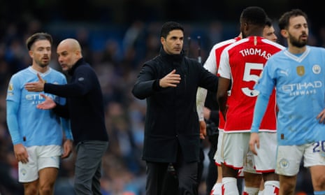 Mikel Arteta and Pep Guardiola talk to their players after the match. 