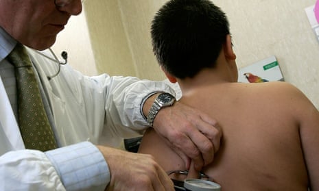 Overweight boy being checked by doctor