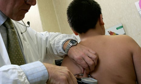 Obese boy gets a checkup from a doctor