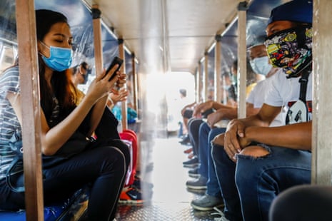 Passengers wearing masks for protection against coronavirus are seated in between plastic barriers to maintain social distancing in a jeepney, in Quezon City, Metro Manila, Philippines, on 3 July, 2020.