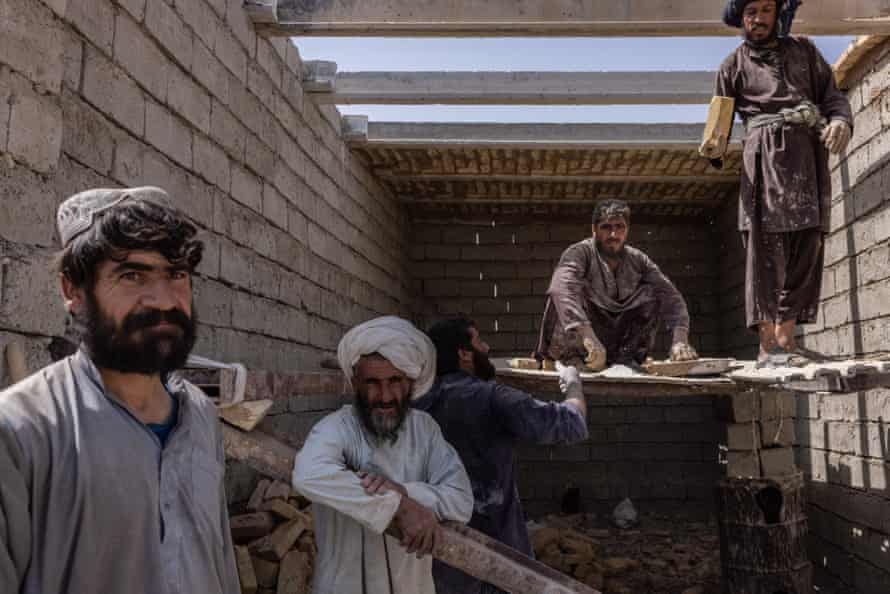 Construction workers in Sangin are starting to rebuild their houses