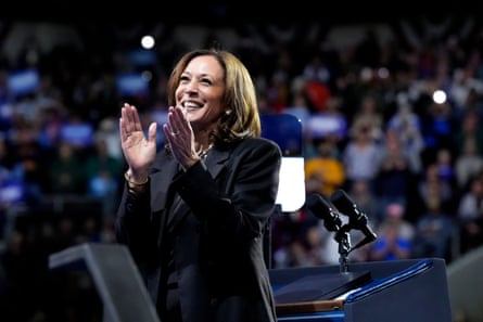 harris smiles and applauds