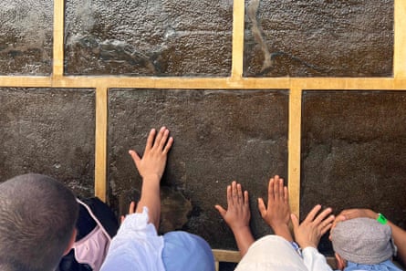 Muslim worshippers touch the Ka’bah, Islam’s holiest shrine on 24 June.