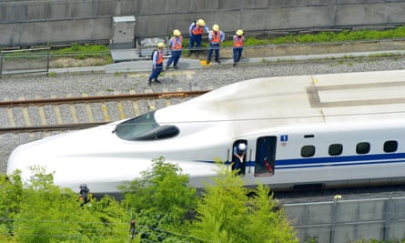 Police officers investigate a Shinkansen bullet train after it made an emergency stop in Odawara.