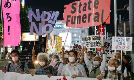 Protesters hold banners in Tokyo last month against the coming state funeral for Shinzo Abe
