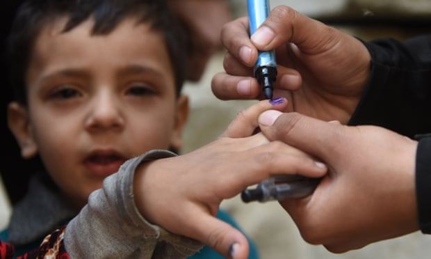A Pakistani health worker marks a child’s finger after administering polio drops during an immunisation campaign in Karachi. 