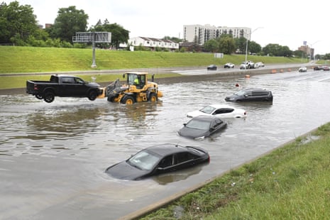 A tractor pulls a truck out of a flooded freeway in Detroit, Michigan.