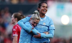 Mary Fowler celebrates with Laura Coombs after netting the first of her double for Manchester City.