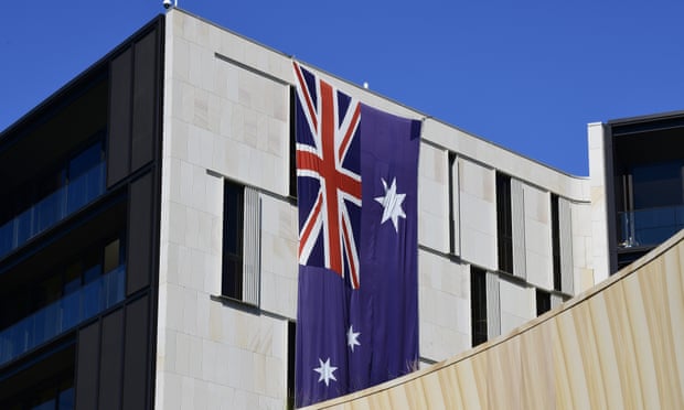 An Australian flag hangs on a building