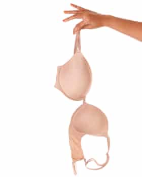 woman’s outstretched hand holding an underwire bra