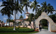Palm trees surround an archway leading to a building