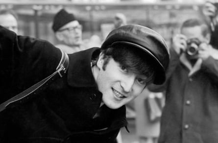 John Lennon in a black cap smiling