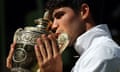 Carlos Alcaraz kisses the trophy after winning the Wimbledon 2024 men's singles final against Novak Djokovic.