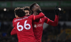 Divock Origi of Liverpool celebrates with Trent Alexander-Arnold and Mohamed Salah after scoring in the dying moments of injury time.