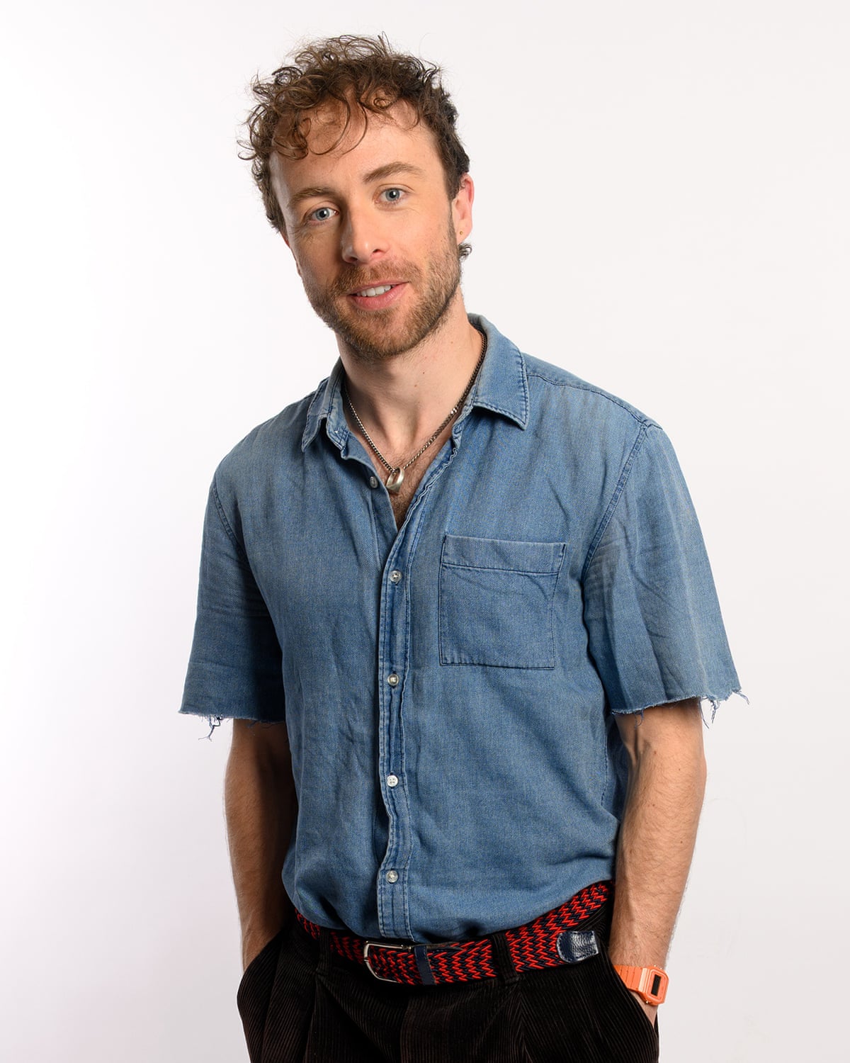 Ben Norris smiles while standing with his hands in his pockets