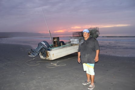 Martín Guadalupe Trasviña, a fisher from the San Juanico Surf cooperative, stands in front of his boat