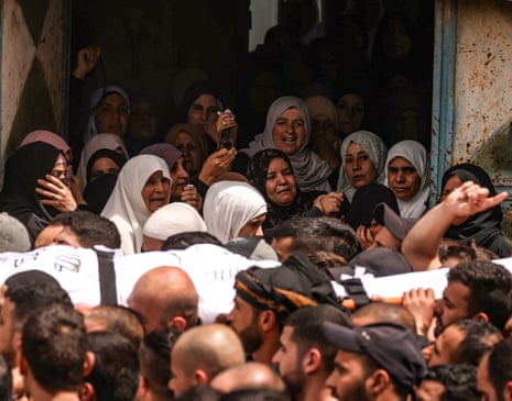 The body of one of two Palestinian men, reportedly killed during an Israeli settlers' attack in the occupied West Bank, is carried by mourners during a funeral procession on Saturday.