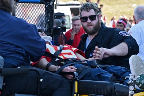 An injured fan on a stretcher receiving medical assistance