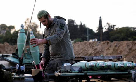 An Israeli soldier prepares mortar shells before firing them as part of the offensive against Gaza.