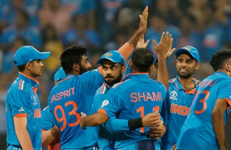Mohammed Shami celebrates with teammates after taking the wicket of New Zealand's Devon Conway
