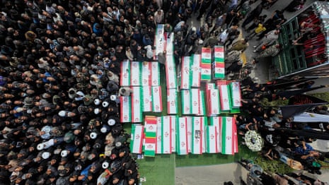 Iranian mourners carry coffns during the funeral of children killed in a U.S.-Israeli airstrike on a primary school in Iran.