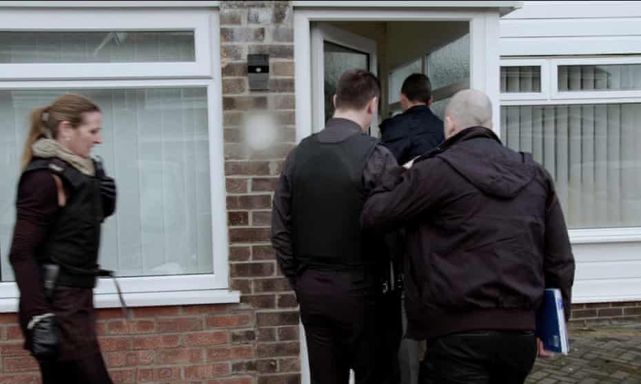 Officers from Greater Manchester police’s public protection team arrive at a house in the city.